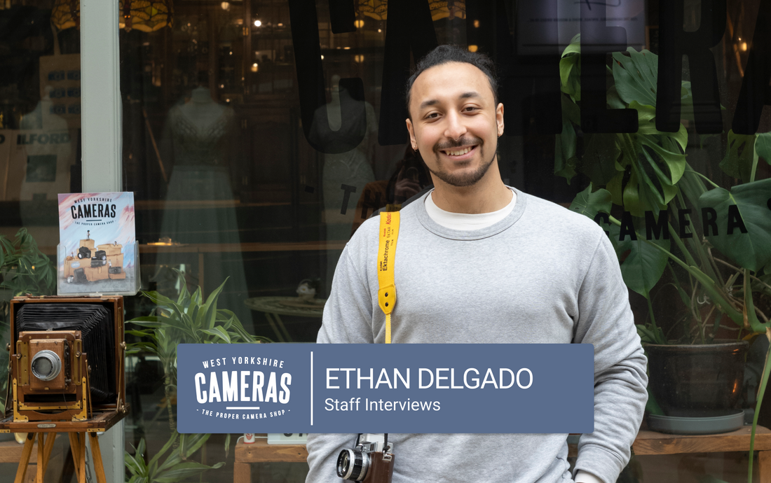 A man stood in front of a camera shop in Leeds.